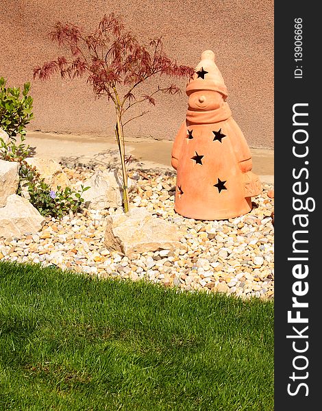 Garden decoration made of trees rocks wood and clay statue