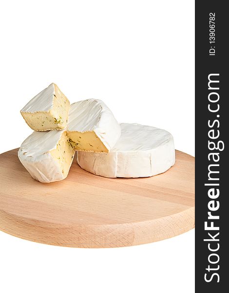 Round camembert block with cut out segment on wooden board over white background. Round camembert block with cut out segment on wooden board over white background.