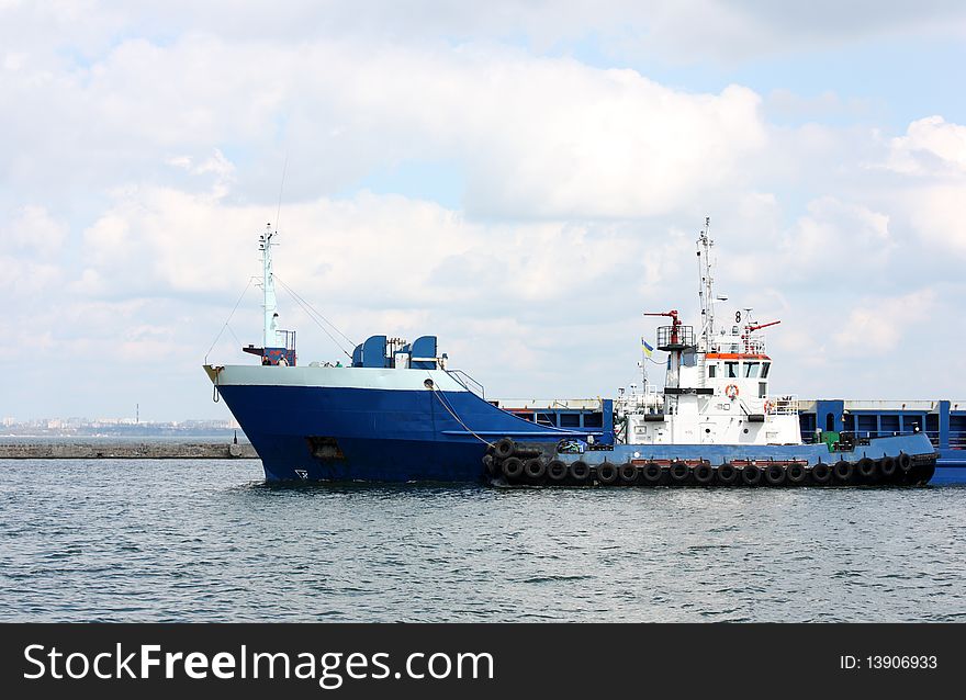 Towboat helps to cargo ship. Towboat helps to cargo ship
