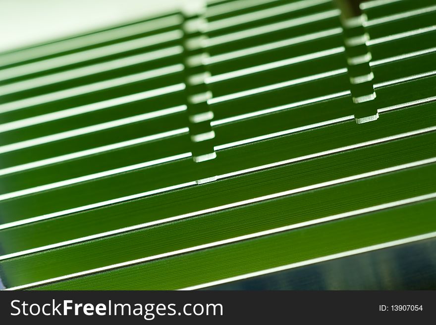 Close-up of a green computer video adapter passive cooler. Shallow dof. Close-up of a green computer video adapter passive cooler. Shallow dof.