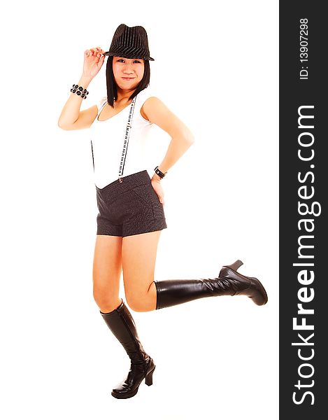 A pretty Asian woman standing on one leg in boots, wearing short shorts, boots with a hat and suspender and white top, for white background. A pretty Asian woman standing on one leg in boots, wearing short shorts, boots with a hat and suspender and white top, for white background.