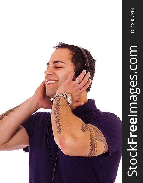 Handsome latino male listening to music with headphones.