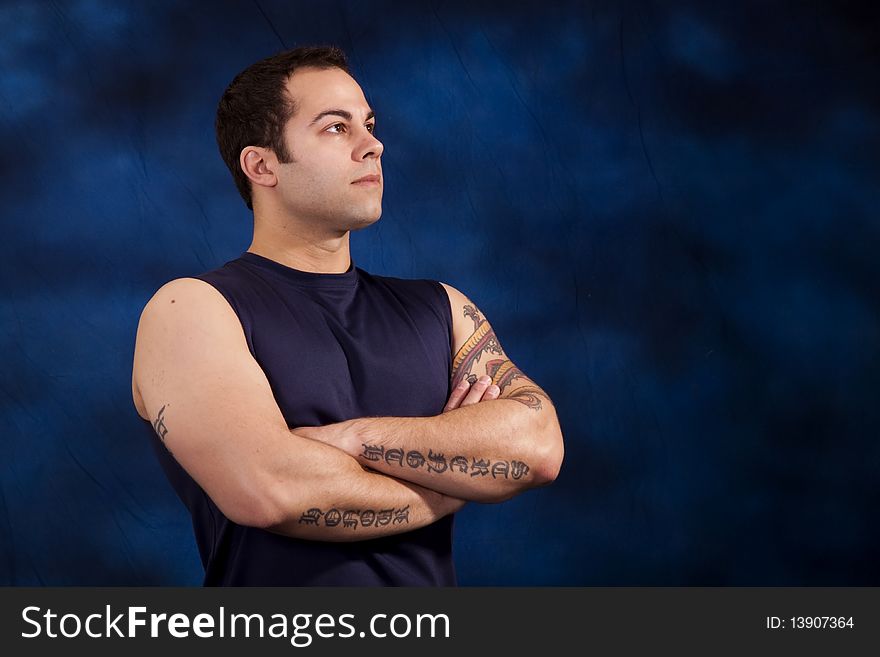 Hispanic man showing off his huge bicep muscles. Hispanic man showing off his huge bicep muscles.