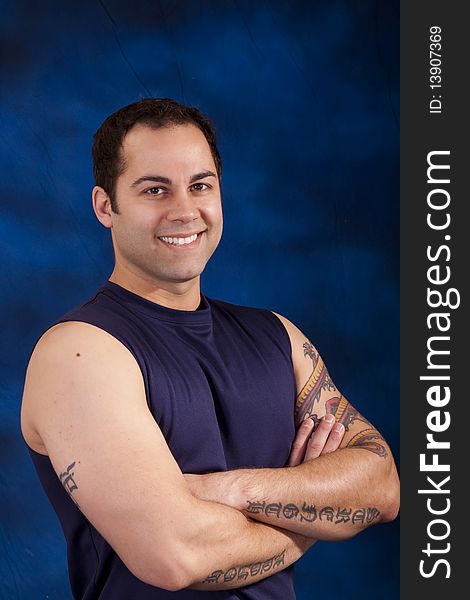 Handsome hispanic man with tattoos on his crossed arms. Handsome hispanic man with tattoos on his crossed arms.