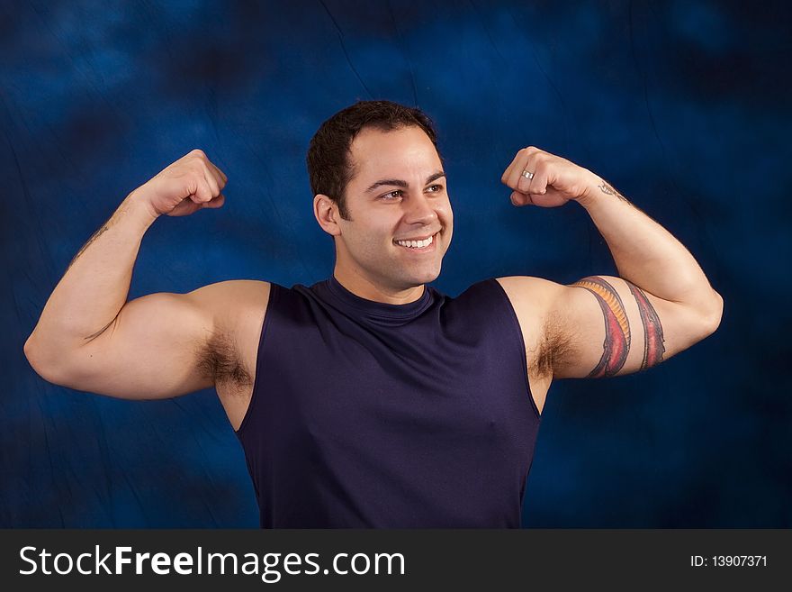 Hispanic man showing off his huge bicep mucles. Hispanic man showing off his huge bicep mucles.