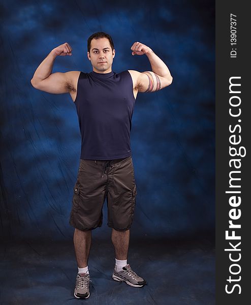 Man with fit back showing his strong arms. Man with fit back showing his strong arms