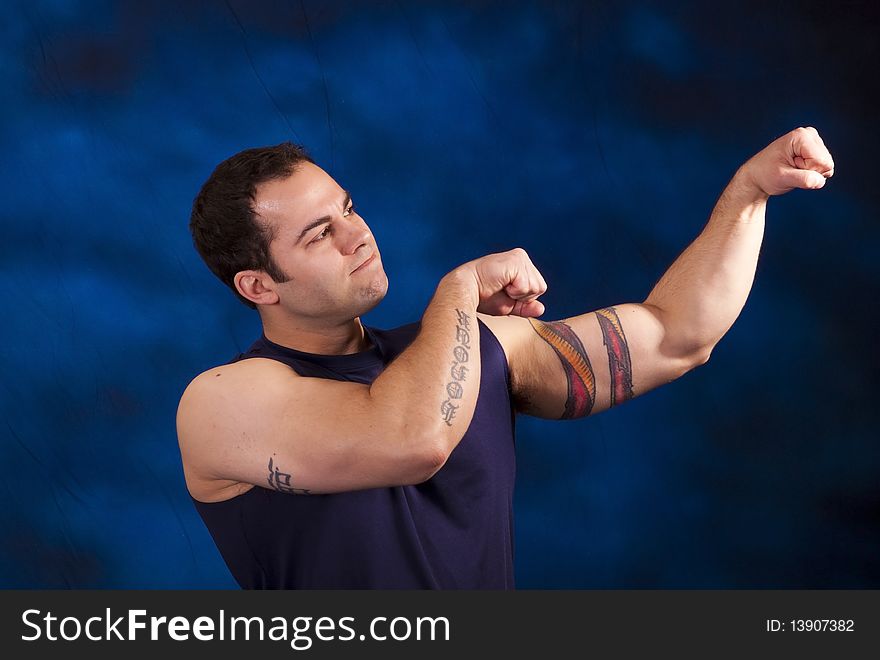 Hispanic man with large bicep muscles. Hispanic man with large bicep muscles