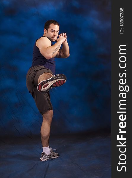 Hispanic man doing Karate for exercise.