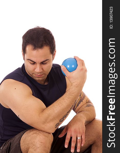 Hispanic man  using small yoga ball weights to build muscles. Hispanic man  using small yoga ball weights to build muscles