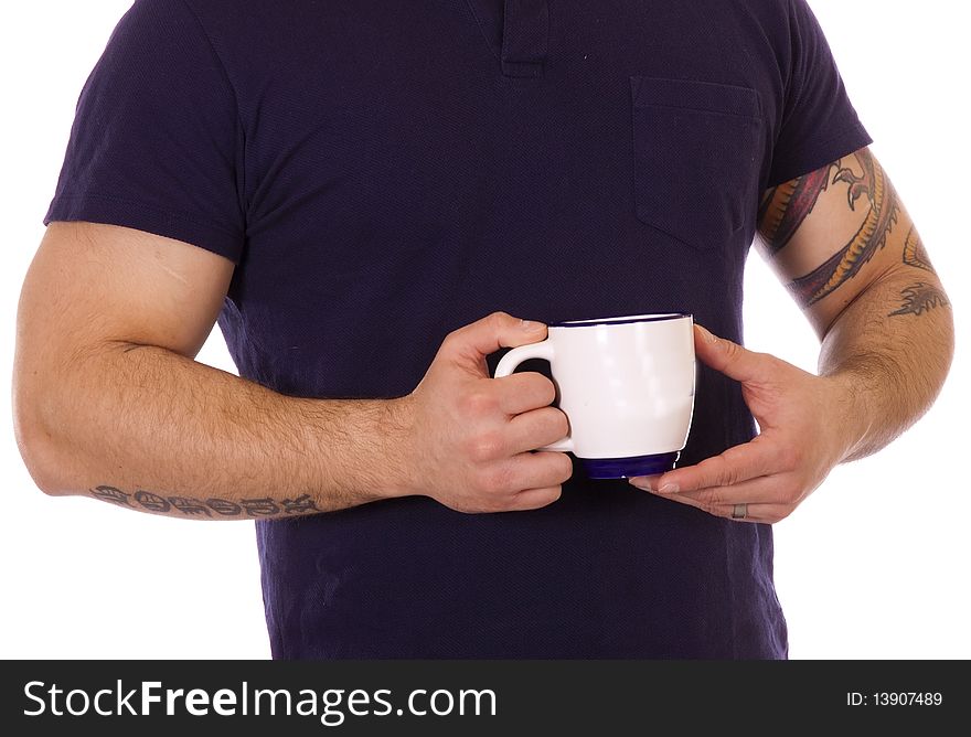 Man with strong arms holding a cup of coffee. Man with strong arms holding a cup of coffee