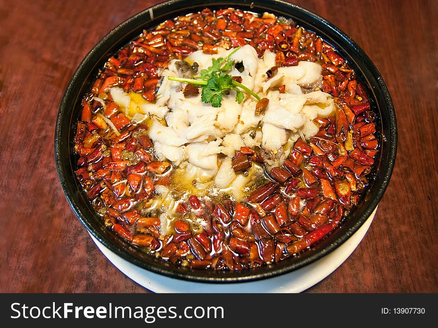 Pepper and fish in a wblack plate,taken in china. Pepper and fish in a wblack plate,taken in china