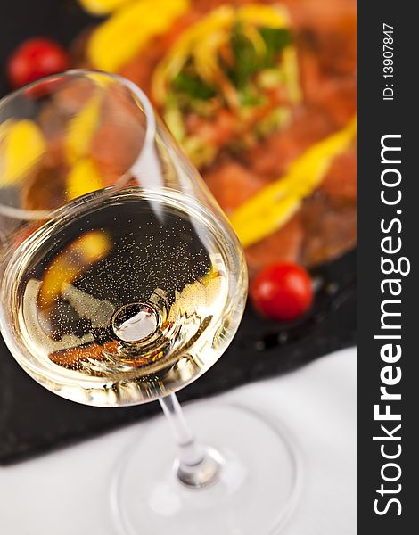 Salmon Carpaccio on Black Dish with White Wine