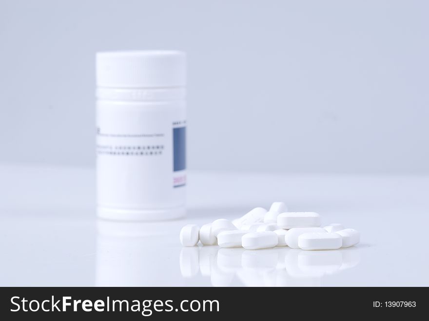 Capsule and bottle on the table. Capsule and bottle on the table