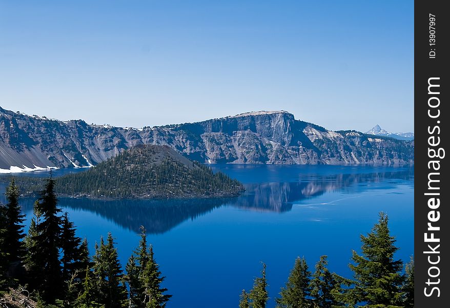 Crater Lake in Oregon with a perfect reflection on a calm sunny day. Crater Lake in Oregon with a perfect reflection on a calm sunny day