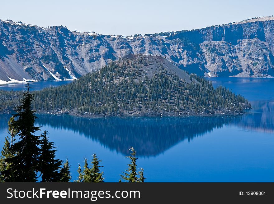 Crater Lake in Oregon with a perfect reflection on a calm sunny day. Crater Lake in Oregon with a perfect reflection on a calm sunny day