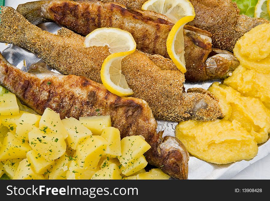 Tasty grilled fish and potatoes. Tasty grilled fish and potatoes