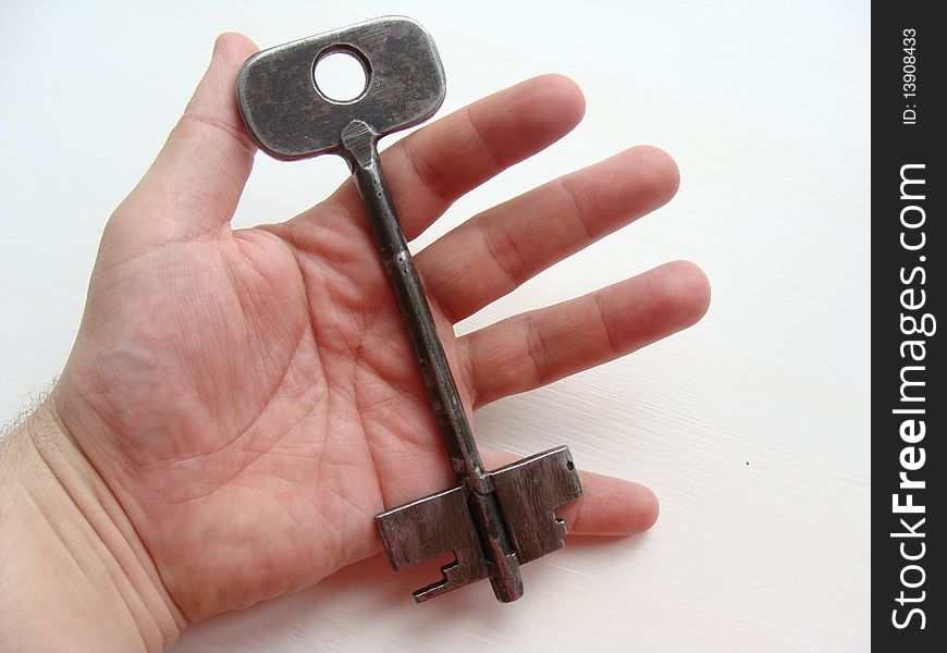 The big metal self-made key in a hand
