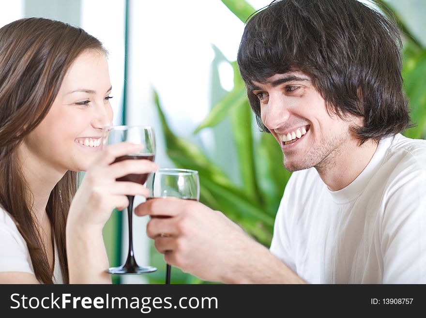 Boy with smile and girl with long hair with wineglasses. Boy with smile and girl with long hair with wineglasses