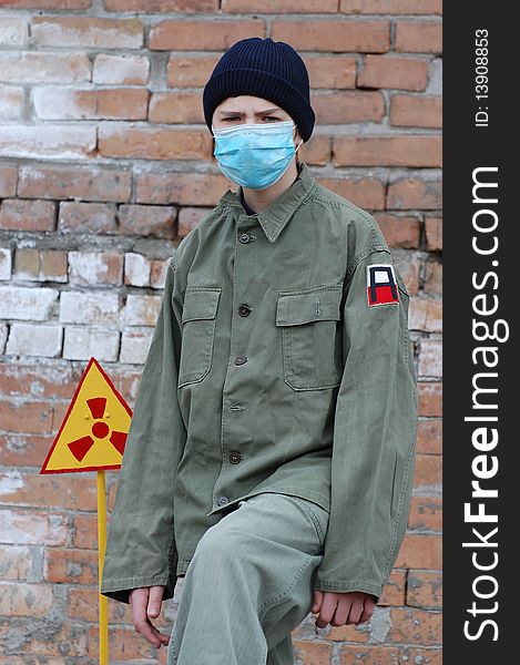 Teenager weared American military uniform.Lost city. Near Chernobyl area. Modern ruins. Ukraine. Kiev region. Teenager weared American military uniform.Lost city. Near Chernobyl area. Modern ruins. Ukraine. Kiev region