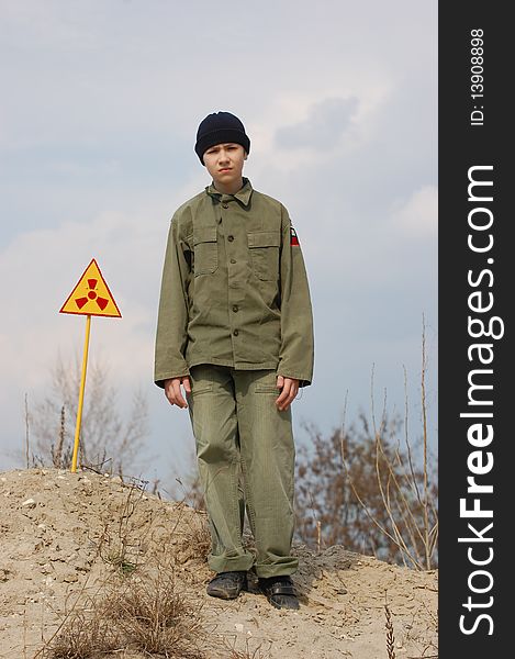 Teenager weared American military uniform.Lost city. Near Chernobyl area. Modern ruins. Ukraine. Kiev region. Teenager weared American military uniform.Lost city. Near Chernobyl area. Modern ruins. Ukraine. Kiev region