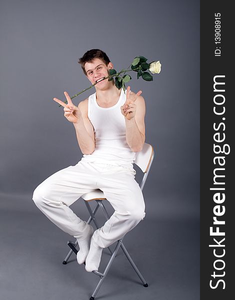 Handsome man with rose in studio