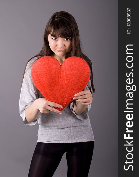 Beautiful woman holding red heart