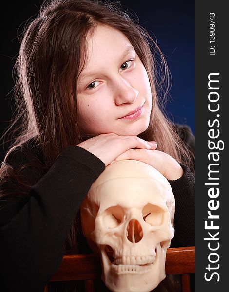 Teenager girl with human skull