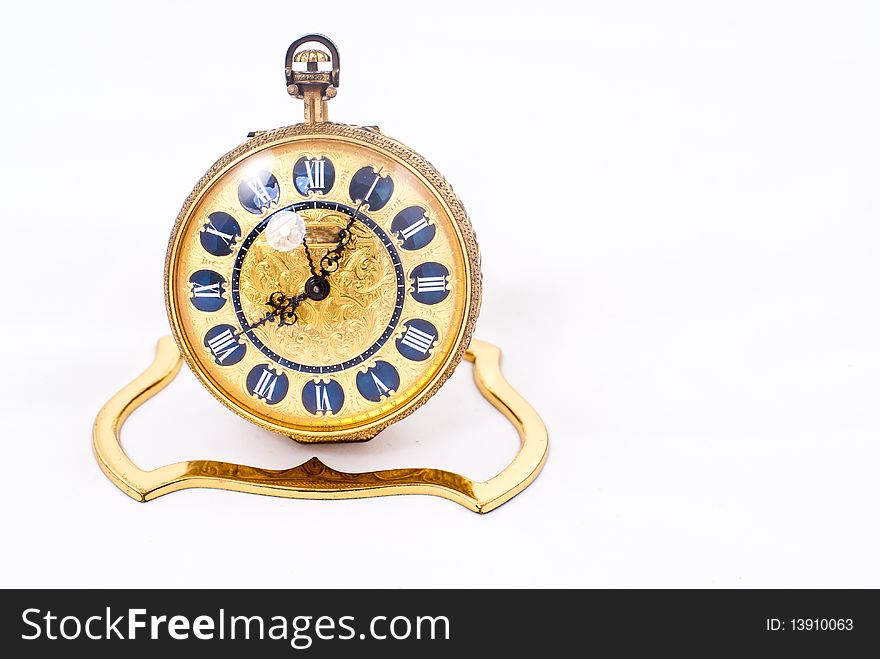 Antique gold clock isolated on a white background. Antique gold clock isolated on a white background