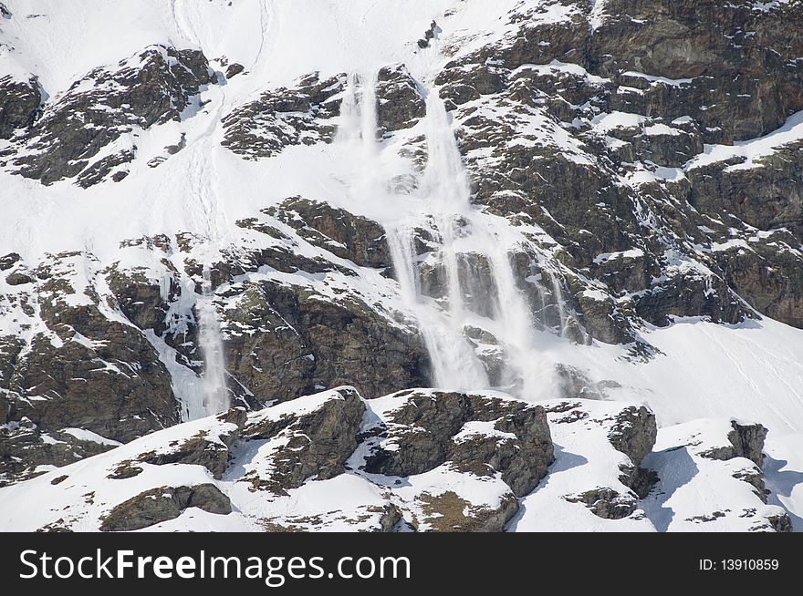 Small avalanche on Mount Cervino in a sunny day.