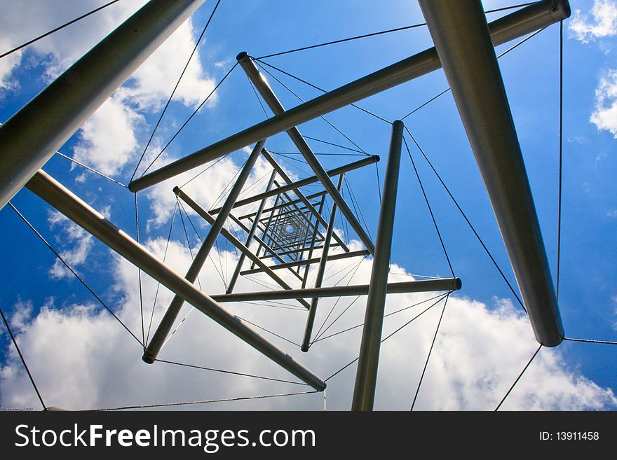 A stainless steel and cable tower structured photographer from below. A stainless steel and cable tower structured photographer from below