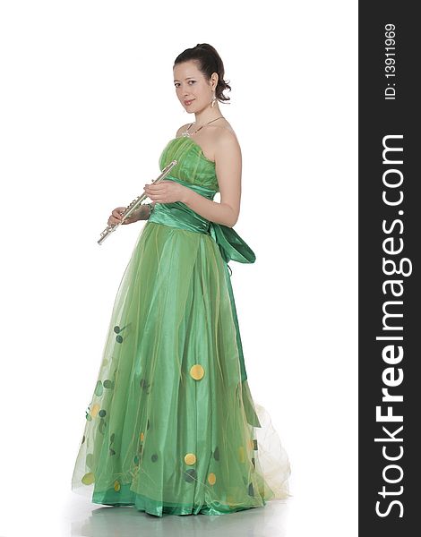 Attractive young female flautist, flutist holding flute. Evening green dress. Studio shot, white background.