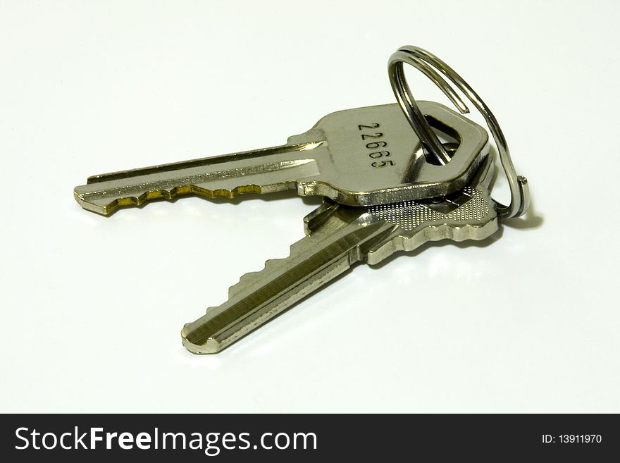A view of pair of keys with key ring isolated on white