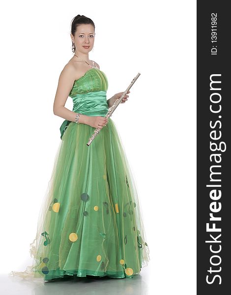 Attractive young female flautist, flutist holding flute. Evening green dress. Studio shot, white background.