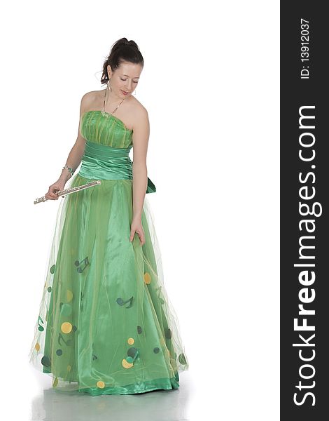 Attractive young female flautist, flutist holding flute. Evening green dress. Studio shot, white background.