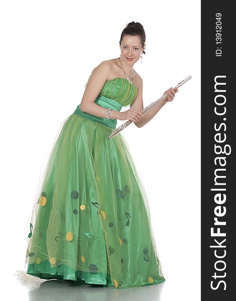 Attractive young female flautist, flutist holding flute. Evening green dress. Studio shot, white background.