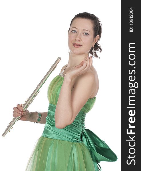 Attractive young female flautist, flutist holding flute. Evening green dress. Studio shot, white background.