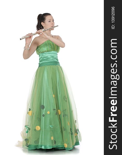 Attractive young female flautist, flutist holding flute. Evening green dress. Studio shot, white background.