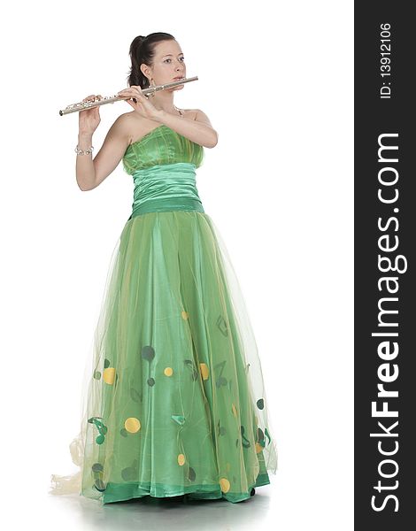 Attractive young female flautist, flutist holding flute. Evening green dress. Studio shot, white background.