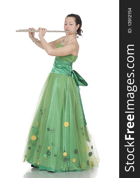 Attractive young female flautist, flutist holding flute. Evening green dress. Studio shot, white background.