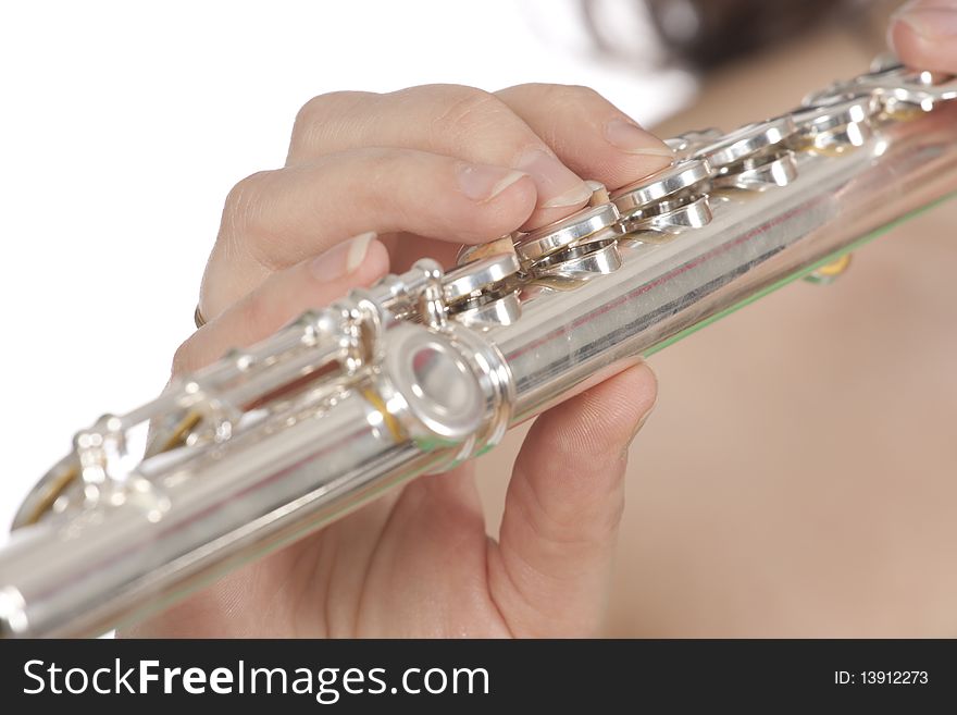 Attractive young female flautist, flutist holding flute. Studio shot, white background.