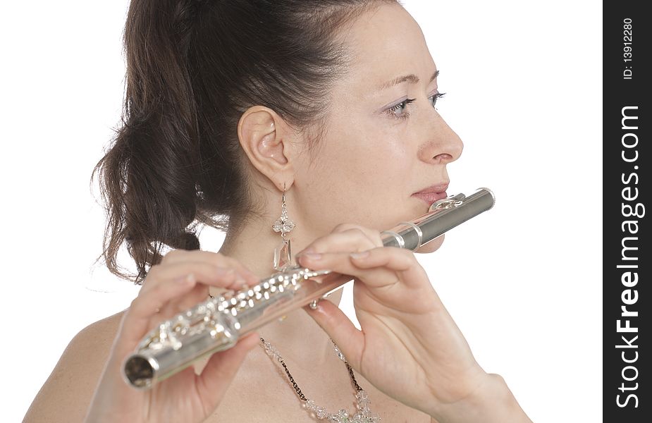 Attractive young female flautist, flutist holding flute. Evening green dress. Studio shot, white background.