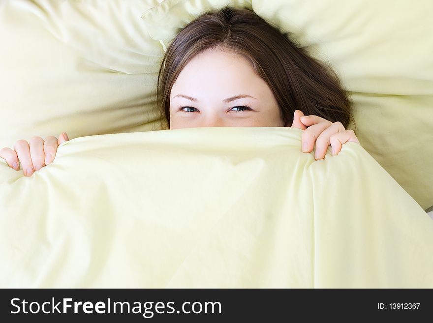 Young beautiful woman smiling in the bed. Young beautiful woman smiling in the bed