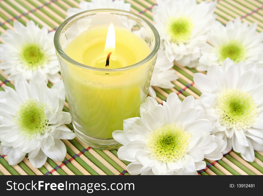 White flowers and green candle. White flowers and green candle
