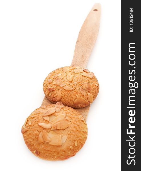 Homemade cookies with almond chips on a wooden spatula isolated on a white background. Homemade cookies with almond chips on a wooden spatula isolated on a white background