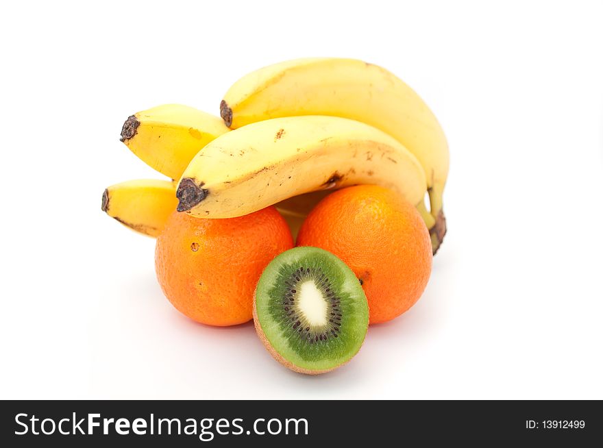 A bunch of bananas, oranges and a kiwifruit isolated on a white background. A bunch of bananas, oranges and a kiwifruit isolated on a white background