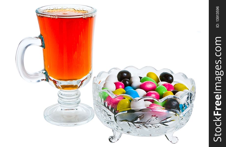 Vase with colour sweets and a tea glass