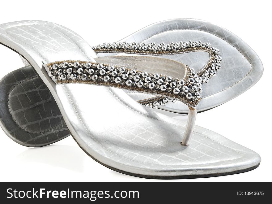 This is a beautiful ladies fancy silver shoes isolated on a white background. This is a beautiful ladies fancy silver shoes isolated on a white background.