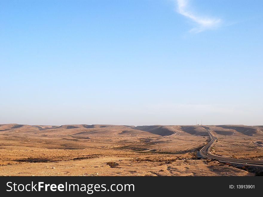 Fragment of Negev desert with mountains on a distance shot. Fragment of Negev desert with mountains on a distance shot