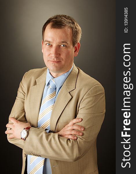 Adult handsome caucasian businessman over grey background. Adult handsome caucasian businessman over grey background