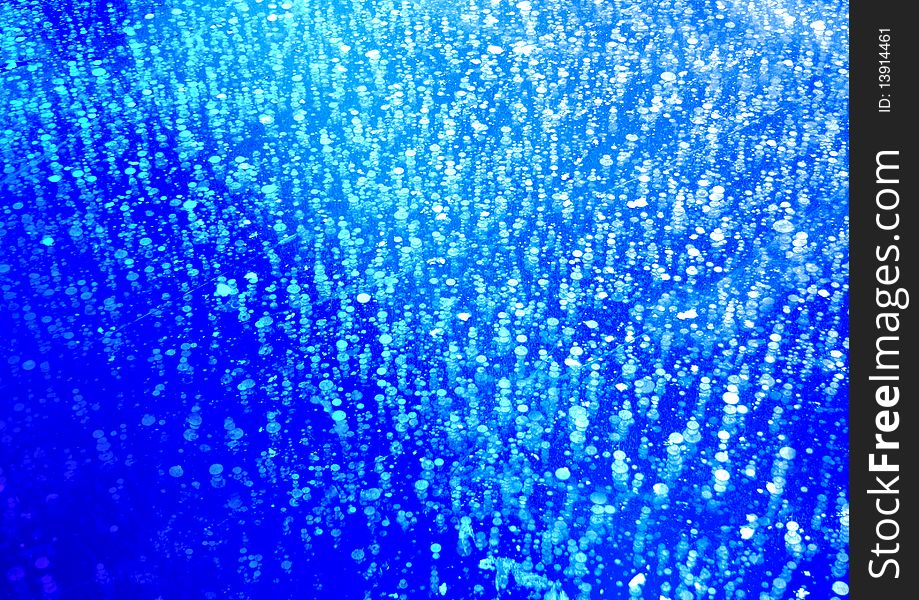 Air bubbles at an ice - abstraction at blue
